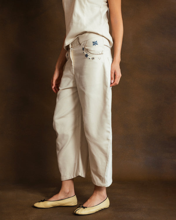 Side view of cream wool-blend Mosaico Bubble Pants showing the sculptural silhouette and pocket detailing.